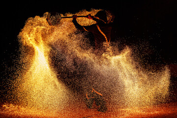 The man during the fire show with a lot of sparks.