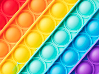 Pop it fidget toy texture rainbow background 