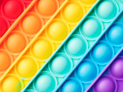 Pop it fidget toy texture rainbow background 