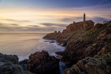 Fototapeta na wymiar Sunset on lighthouse of Vilan cape in Galicia Spain
