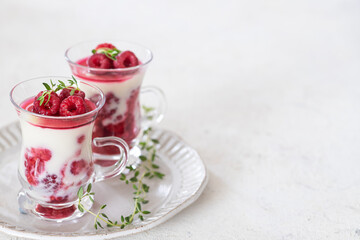 Healthy breakfast: yogurt parfait with fresh raspberries	