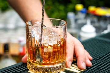 A glass of whiskey with ice.