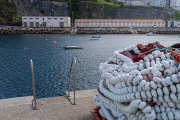 Fishing nets and floats in the dock of Malpica Galicia Spain next to a starway