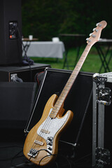 Bass guitar and the amp on the outdoor stage.