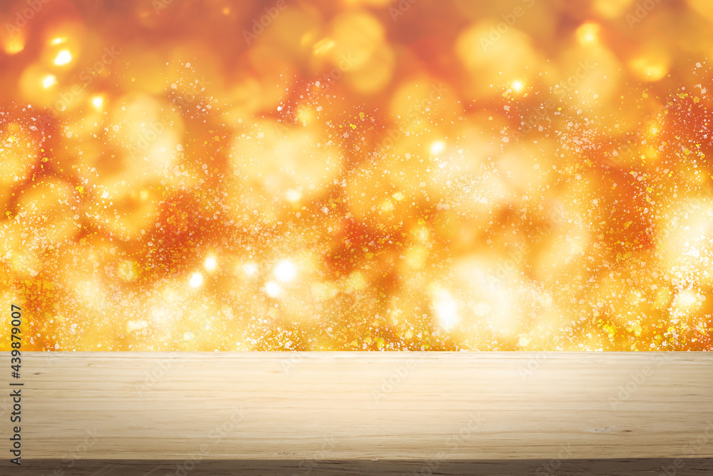 Poster gold and red color bright lights bokeh background of wooden table in front of lights abstract blurre