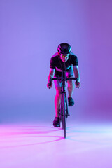 Cyclist riding a bicycle isolated against neon background