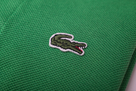 Mulhouse - France - 16 June 2021 - Closeup of lacoste logo on green Lacoste shirt on white background, Lacoste is the famous french luxury brand of sportswear