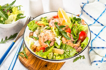 Seafood salad with fresh leaves tomatoes and fried seafood. Mediterranean diet.