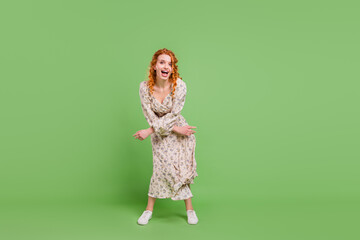 Full size photo of cheerful happy young positive woman dance good mood isolated on green color background