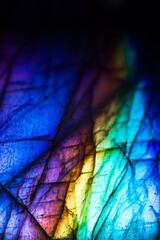Detail of colorful multicolored (blue, yellow, purple, cyan, blue) labradorite gemstone. Close-up...