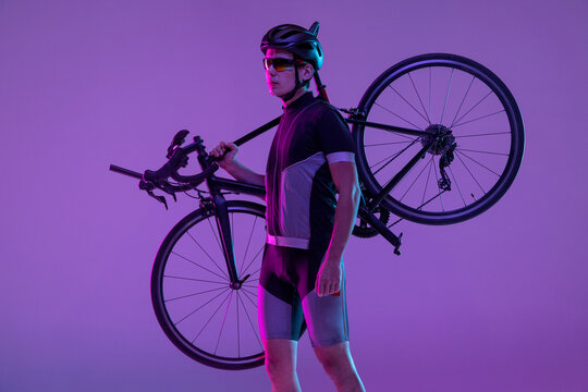 Cyclist Riding A Bicycle Isolated Against Neon Background