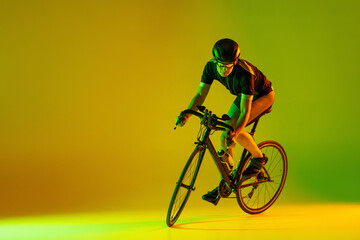 Cyclist riding a bicycle isolated against neon background