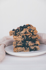 Homemade oatmeal scones with berries stacked on white plate. Vegan sweet baked food. Gluten free...