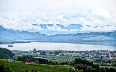 Fototapeta na wymiar Czorsztyn lake in Knurow in Poland and Tatra mountains in clouds.