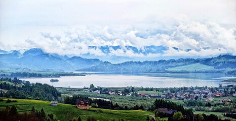 Fototapeta na wymiar Czorsztyn lake in Knurow in Poland and Tatra mountains in clouds.