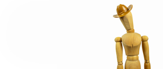 Wooden mannequin in a cowboy hat on a white background. Side view, place for text.