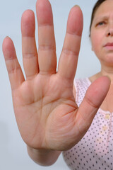 woman shows the palm of her hand, demonstrates the lines of life, love, stop concept, palmistry,...