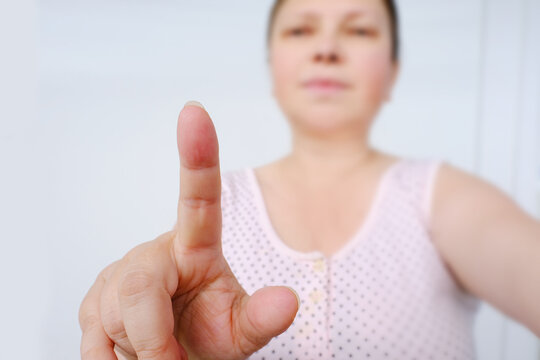 Woman Shows With Index Finger, Demonstrates Concept, Attention, Basis For Designer To Add Context, Copy Space