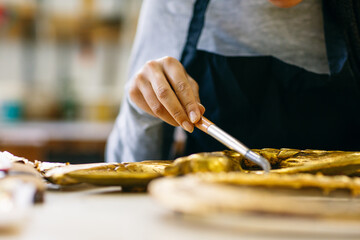 Craftsman restoring carved decorative detail 