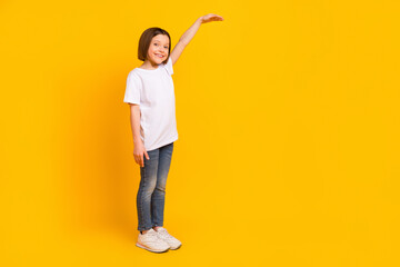 Full length body size photo schoolgirl showing size heigh copyspace smiling happy isolated vibrant yellow color background