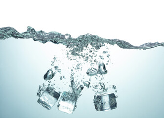 blue water surface with splash air bubbles and ice cubes