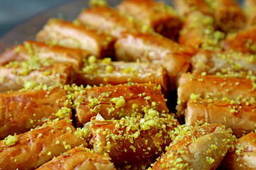 Closeup Rows of Delectable Baklava Pastries Topped with Chopped Pistachio Nuts 