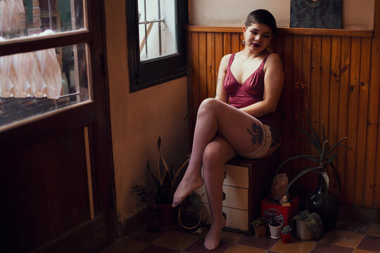 Attractive sexy brunette lace lingerie looking through the window