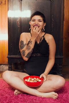 Beautiful woman with short hair eating pop corn