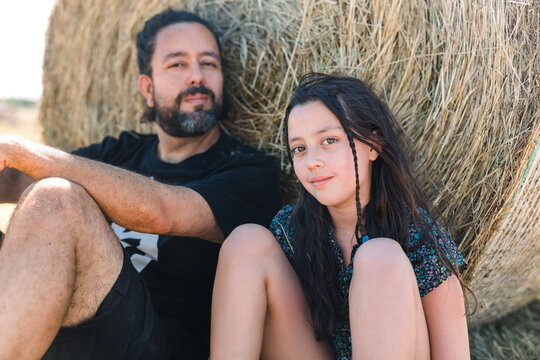 Father daughter sitting on the field