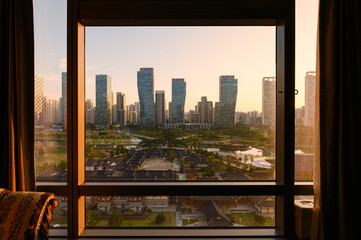 View of high-rise building with traditional hotel in Songdo central park in sunrise morning