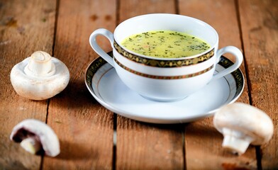 Vegetable soup on a plate on the wooden table