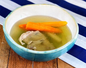 Vegetable soup on a plate on the wooden table