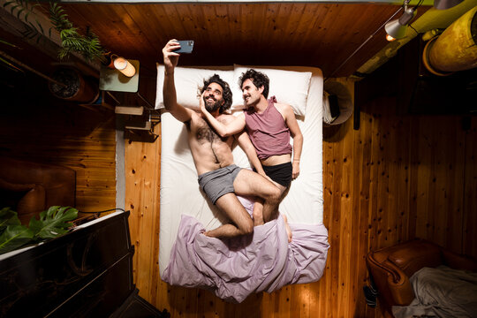 Men couple having fun with smartphone