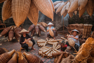 Vietnamese fishermen are doing basketry for fishing equipment at morning in Thu Sy Village, Vietnam. - obrazy, fototapety, plakaty