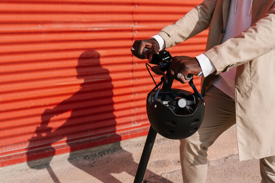 Hands on the handlebars of the electric scooter