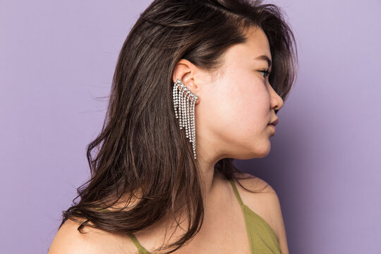 Portrait of a woman in green dress with an ear cuff