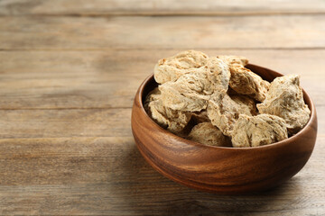 Dried soy meat on wooden table. Space for text
