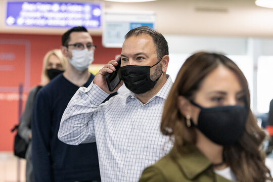 Travel: Man Uses Smart Phone While Waiting To Board Flight