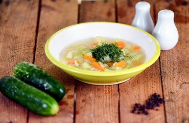 Vegetable soup on a plate on the wooden table