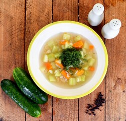 Vegetable soup on a plate on the wooden table