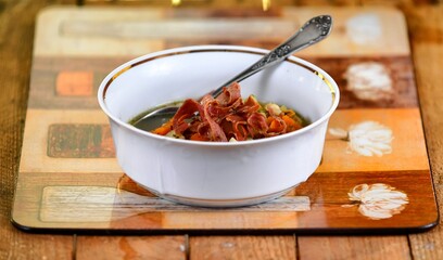 Vegetable soup on a plate on the wooden table