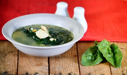 Vegetable soup on a plate on the wooden table