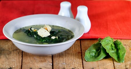 Vegetable soup on a plate on the wooden table
