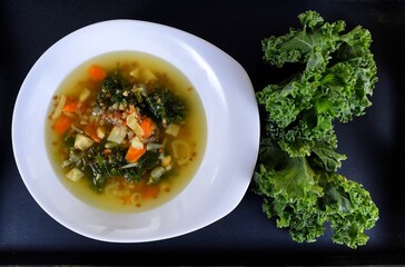 Vegetable soup on a plate on the wooden table