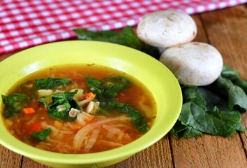 Vegetable soup on a plate on the wooden table