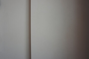Background image of a white wall with a line and shadows