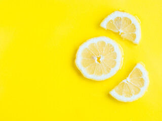 Intense yellow lemon citrus slice in water, texture summer background