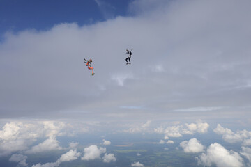 Naklejka na ściany i meble Skydiving. Two skydivers are flying in the sky. Freefly.