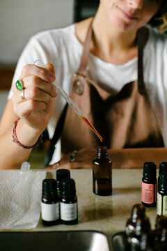Woman perfumer creating an oil scent