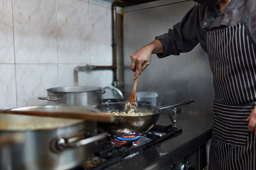 Chef cook food at industrial kitchen